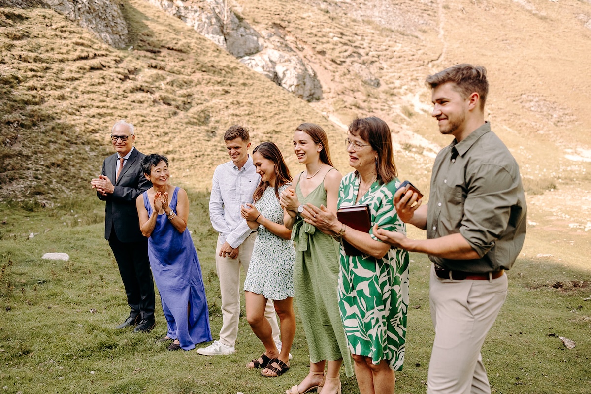 Guests clapping as the couple complete their elopement ceremony in the hills.