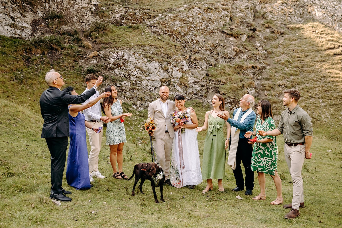Family group laughing together after the ceremony in the Peak District valley.