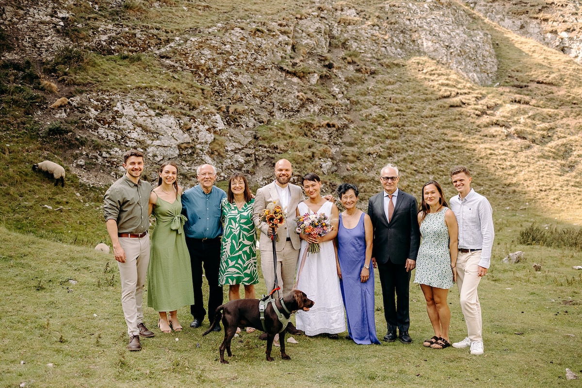 Formal family portrait group gathered in the grass after the Peak District elopement ceremony.
