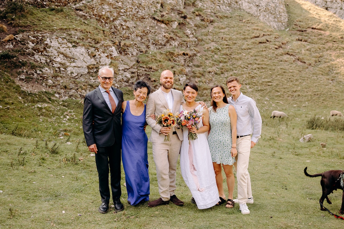 Family portrait with the limestone cliffs behind them during the Peak District elopement.