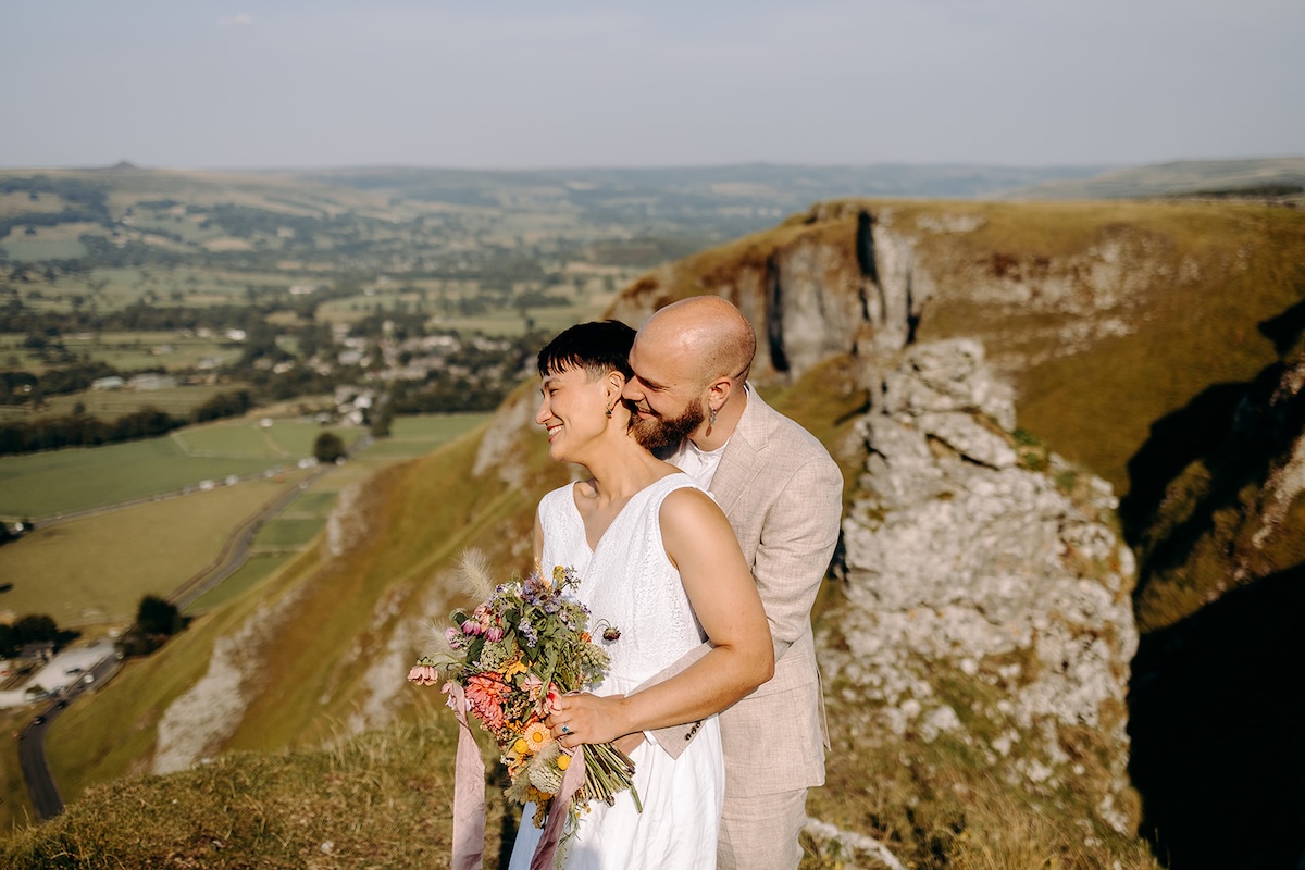 Black and white cliffside bridal portrait documented by a Peak District elopement photographer.