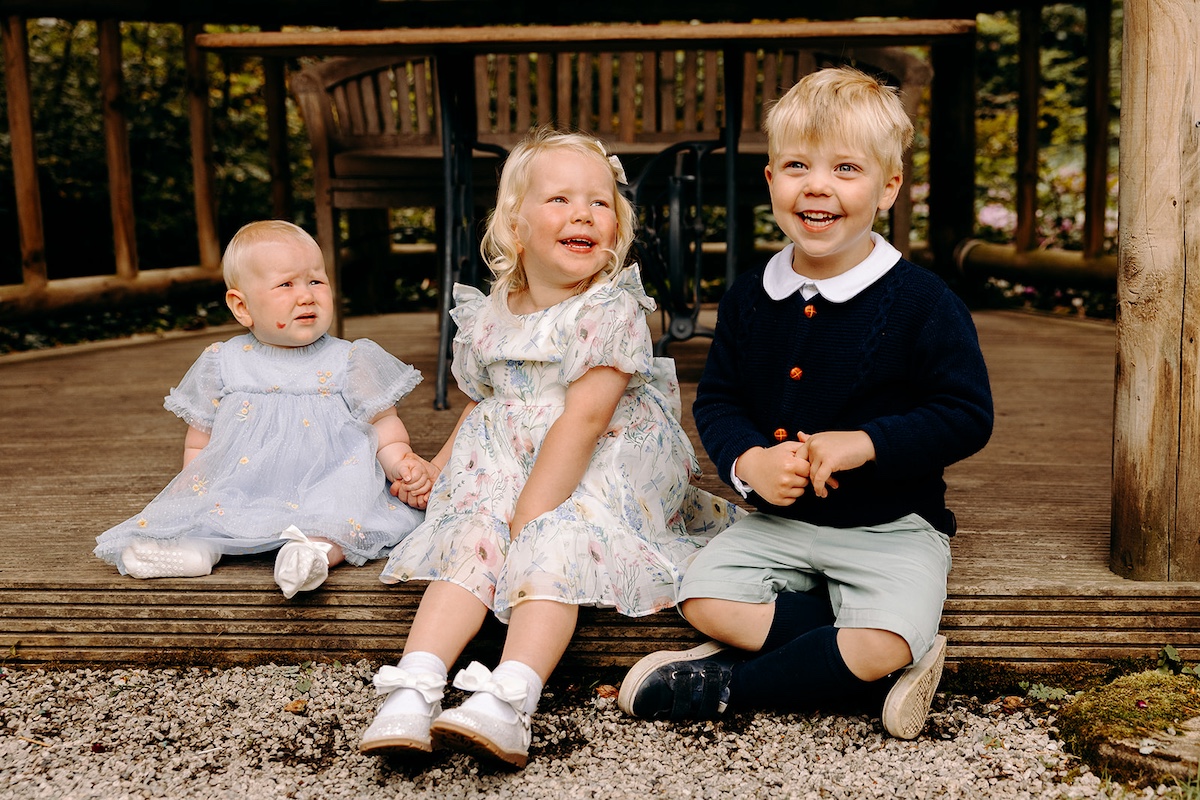Natural family group photograph on lawn at Eyam Hall – Derbyshire wedding photographer.