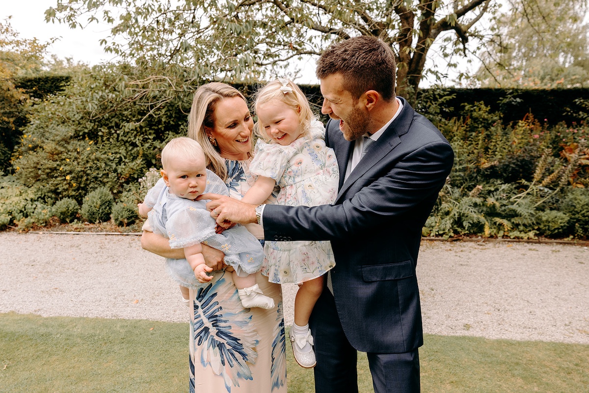 Natural family group photograph on lawn at Eyam Hall – Derbyshire wedding photographer.