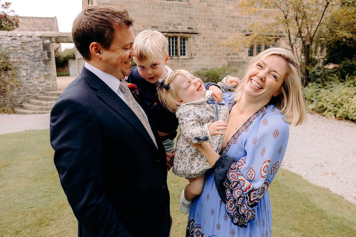 Natural family group photograph on lawn at Eyam Hall – Derbyshire wedding photographer.