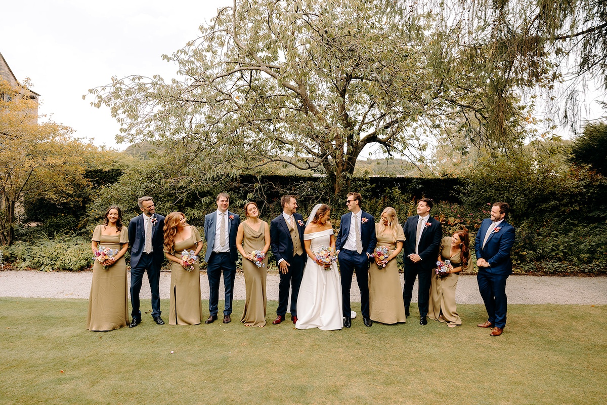Full wedding party group photograph at Eyam Hall – big Peak District wedding celebration.