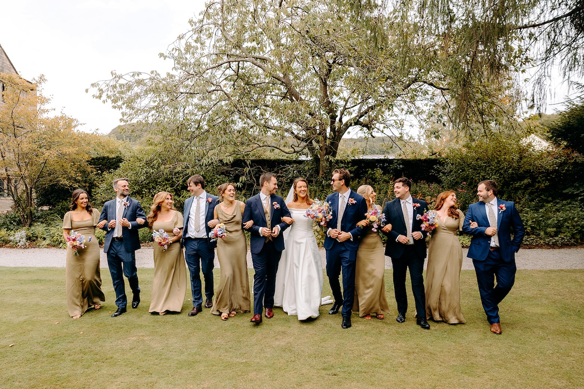 Full wedding party group photograph at Eyam Hall – big Peak District wedding celebration.