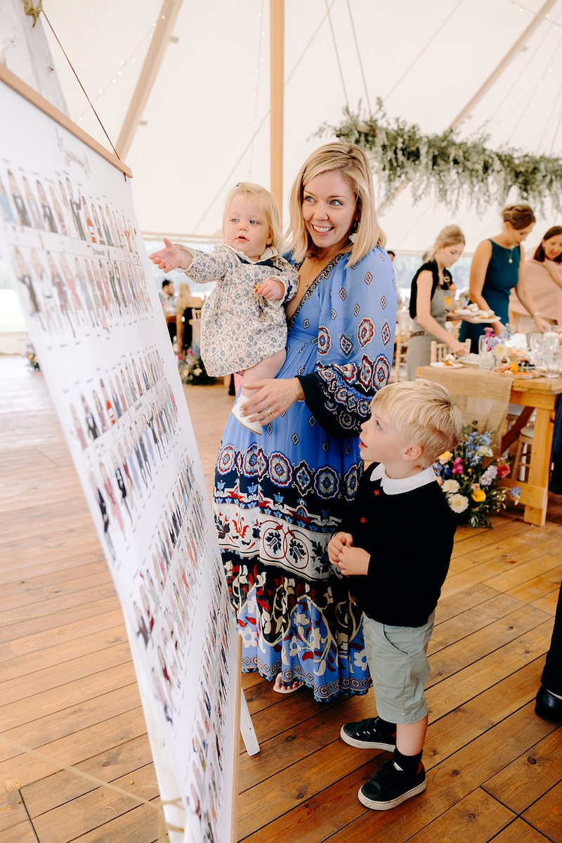 Wedding guests laughing and cheering together during drinks reception at Eyam Hall marquee wedding.