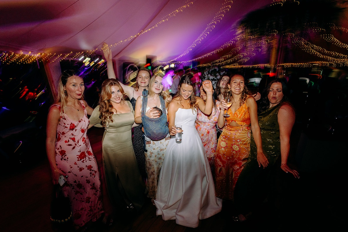 Fun group photo of bride and friends on the dancefloor at Eyam Hall wedding.