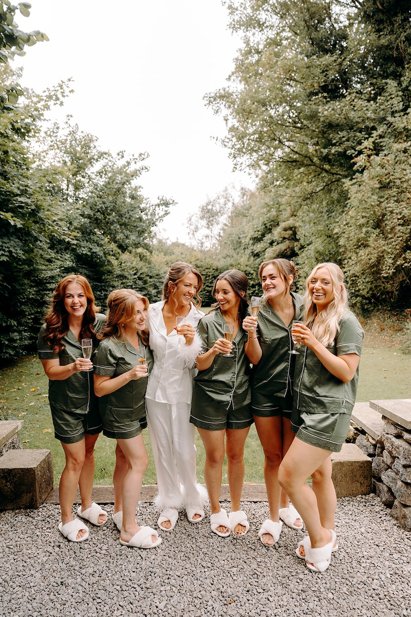 Bridesmaids laughing together during bridal prep before ceremony at Eyam Hall wedding.