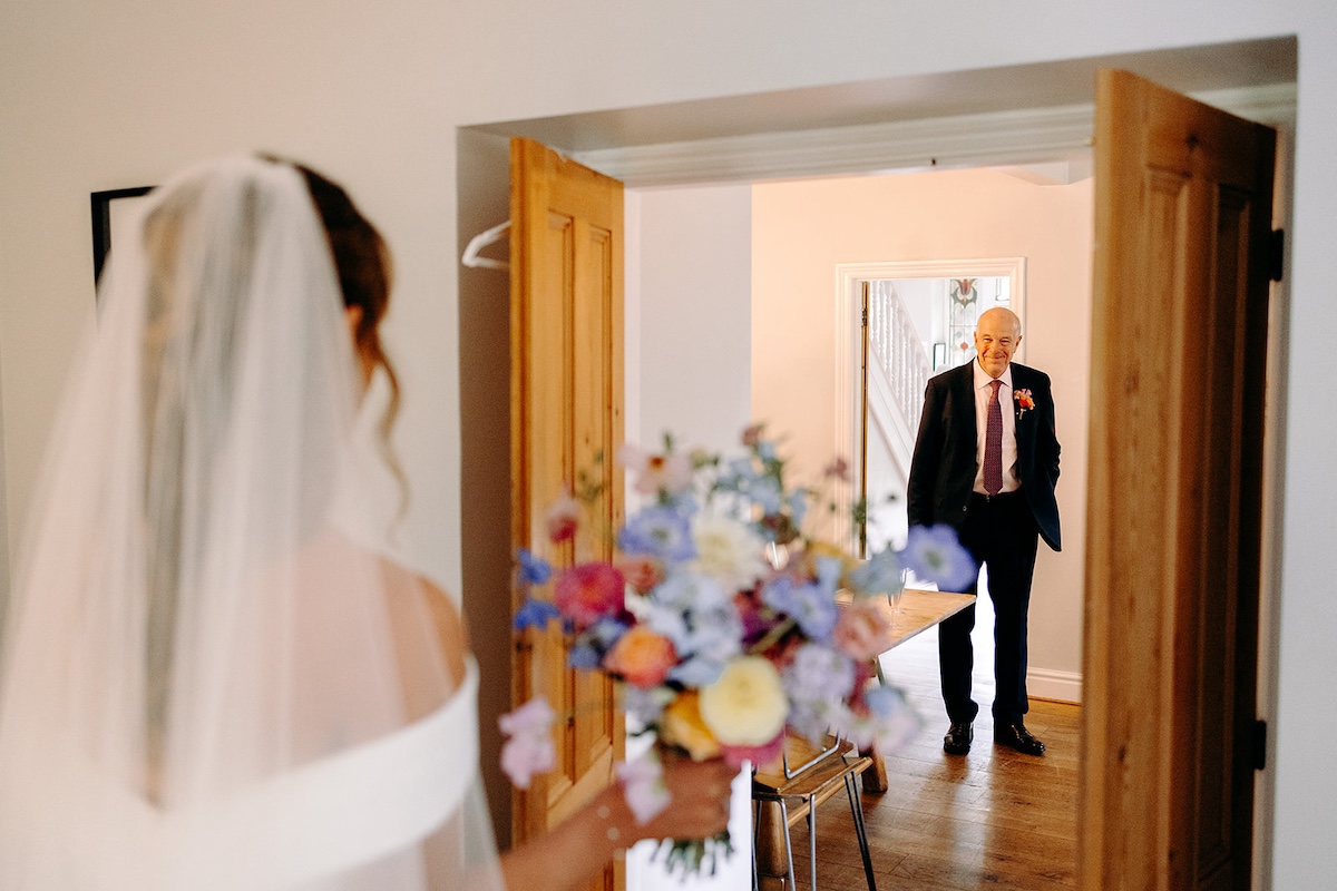 Emotional hug between bride and father of the bride during getting ready at Eyam Hall.