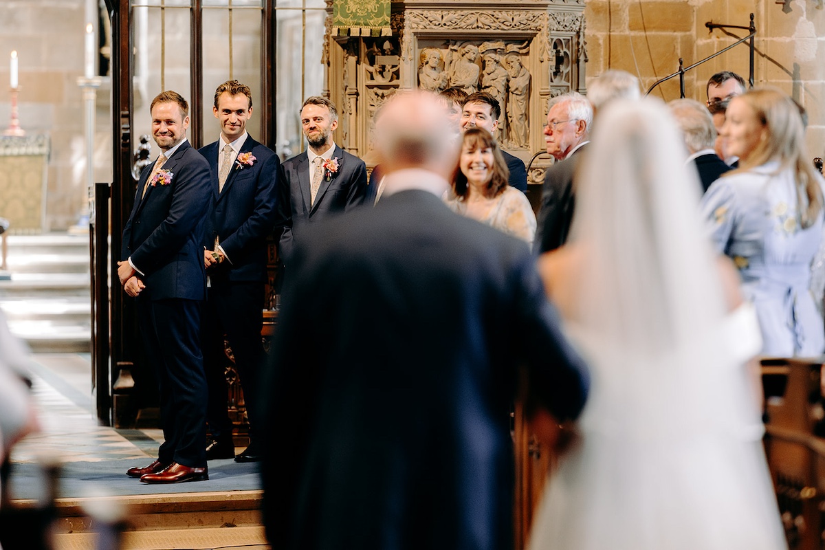 Emotional moment of groom seeing the bride for the first time during Peak District wedding ceremony.