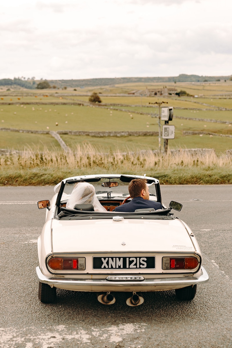 Wedding car driving back to Eyam Hall.