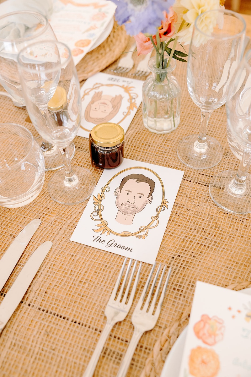 Close-up of wedding place settings with name cards and silver cutlery at Eyam Hall reception.