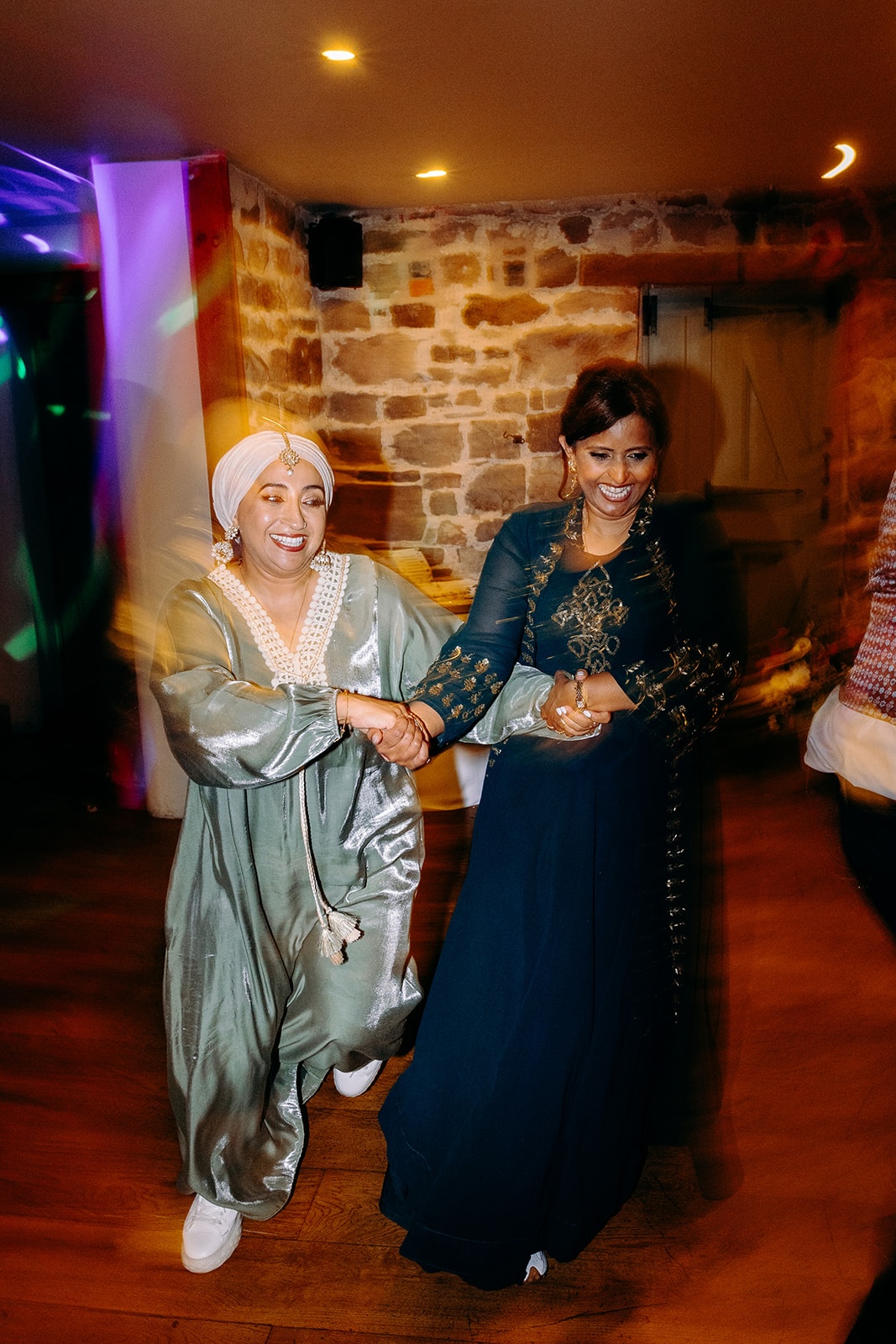 Lively ceilidh dancing with guests spinning and laughing on the dance floor at Ashes Barns.