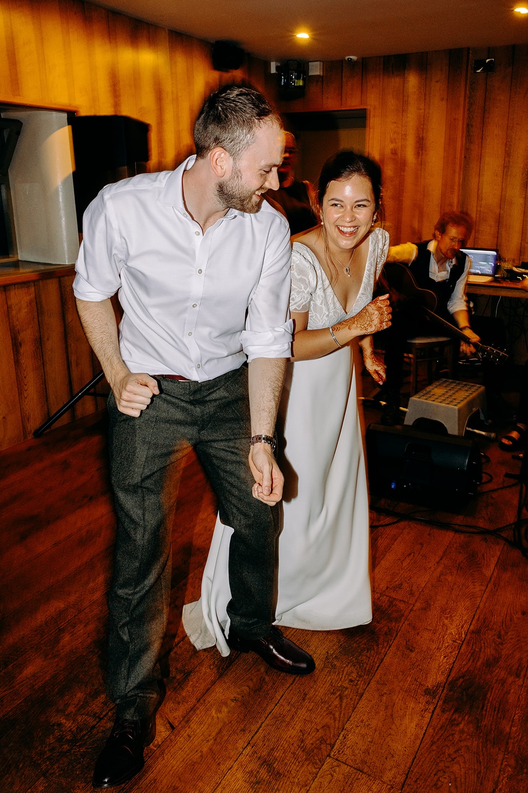 Natural photo of bride and groom dancing a ceilidh together at The Ashes Barns.