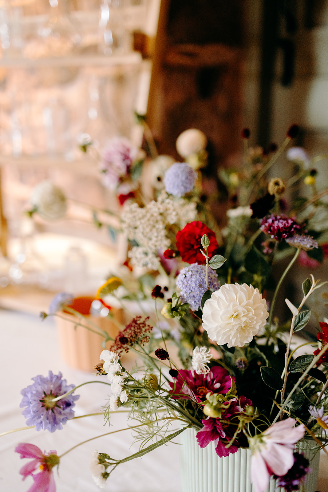 Pick your own flowers wedding table styled against rustic stone walls at Ashes Barns.