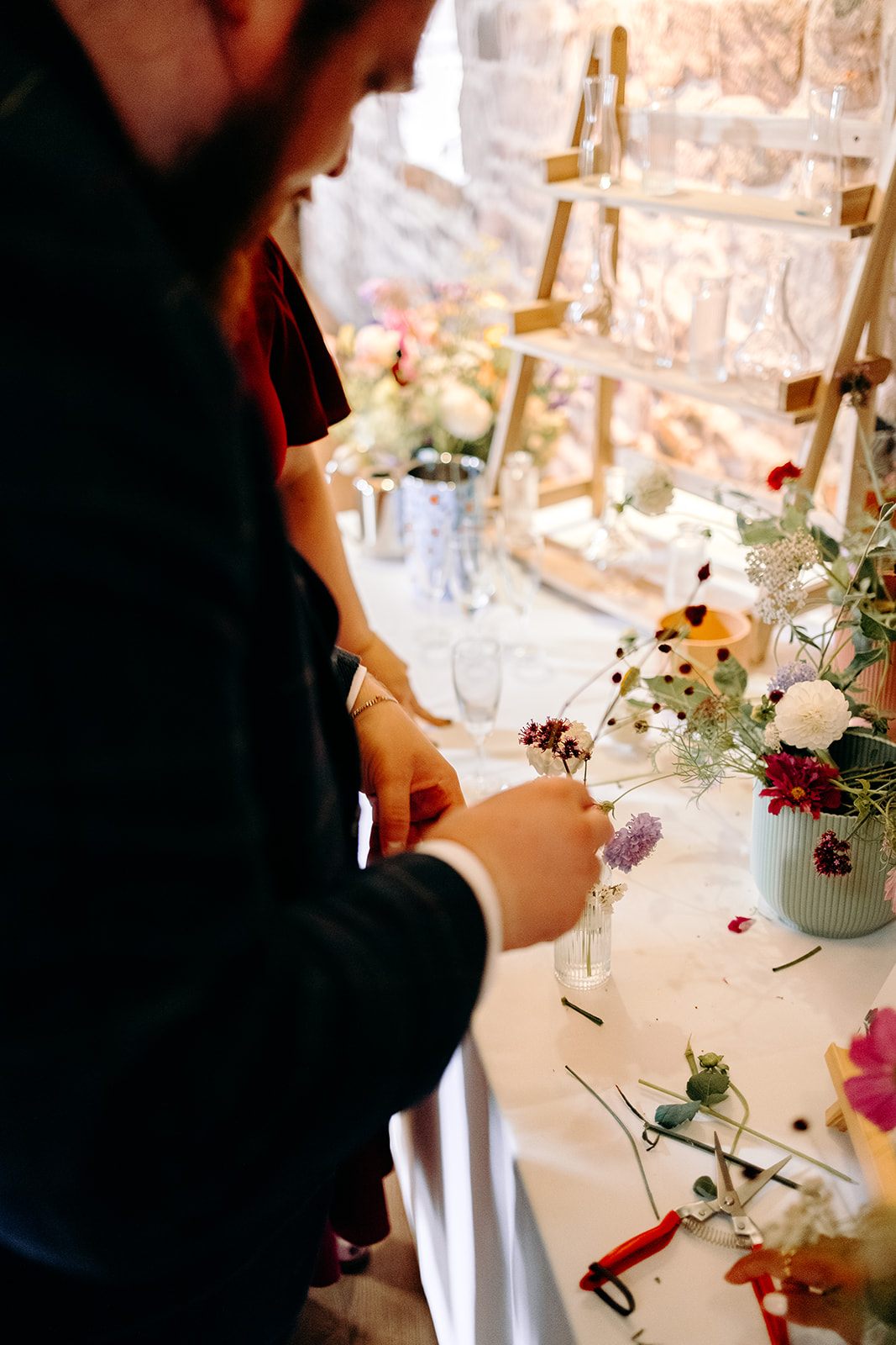 Pick your own flowers wedding table styled against rustic stone walls at Ashes Barns.