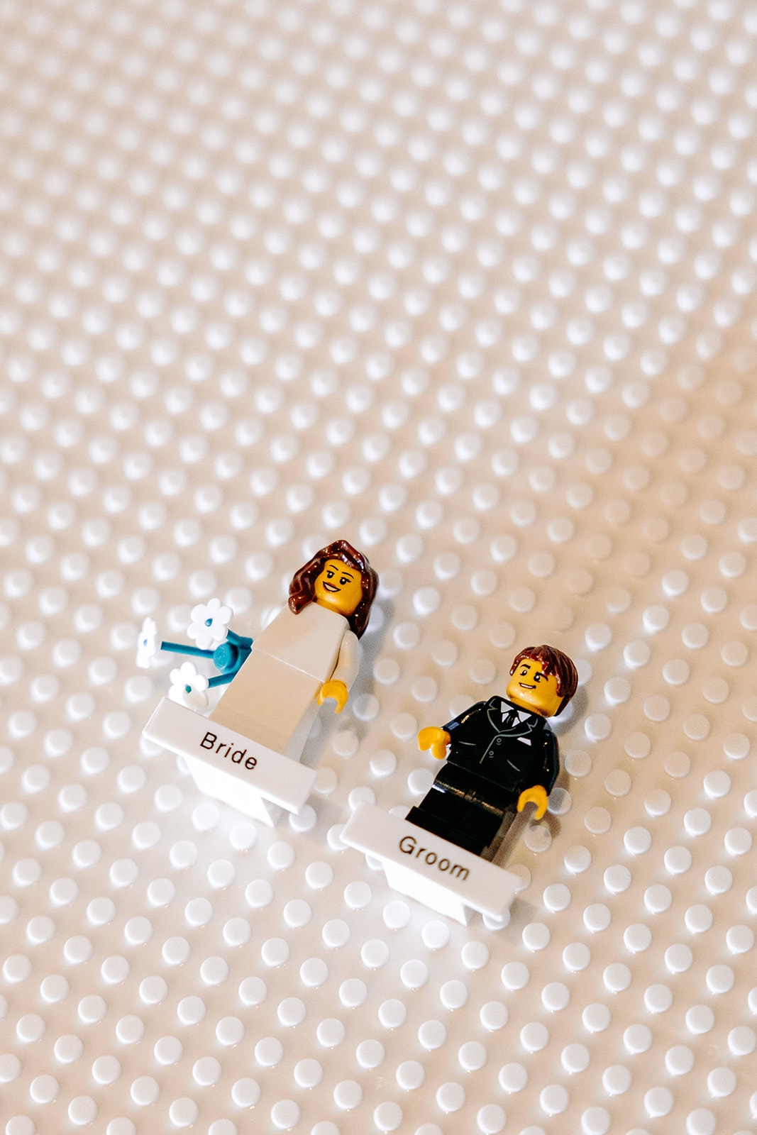 Lego bride and groom figures styled as a fun wedding detail on a table at Ashes Barns.