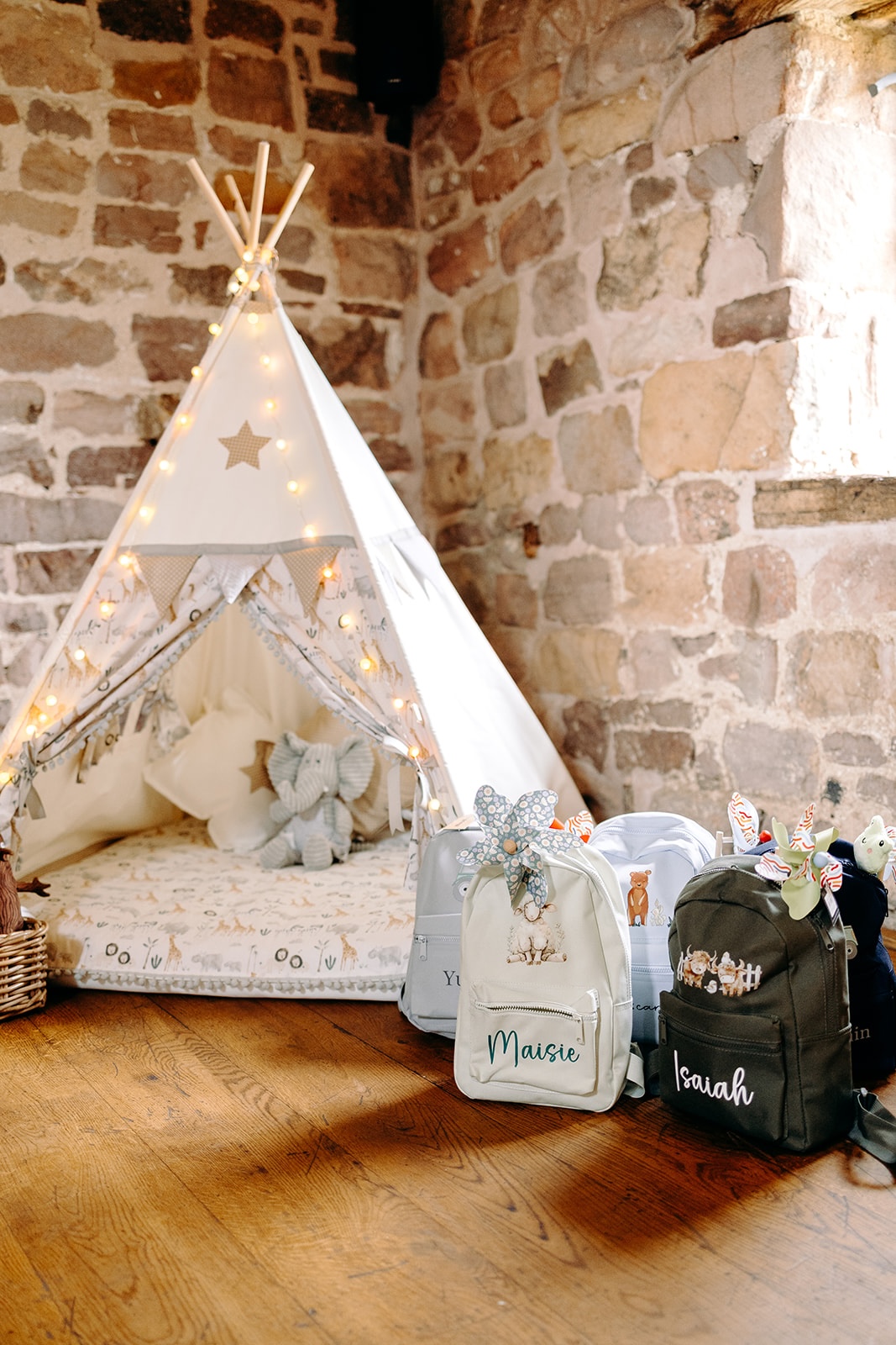 Cosy teepee set up inside Ashes Barns as a relaxed space for children during the wedding day.