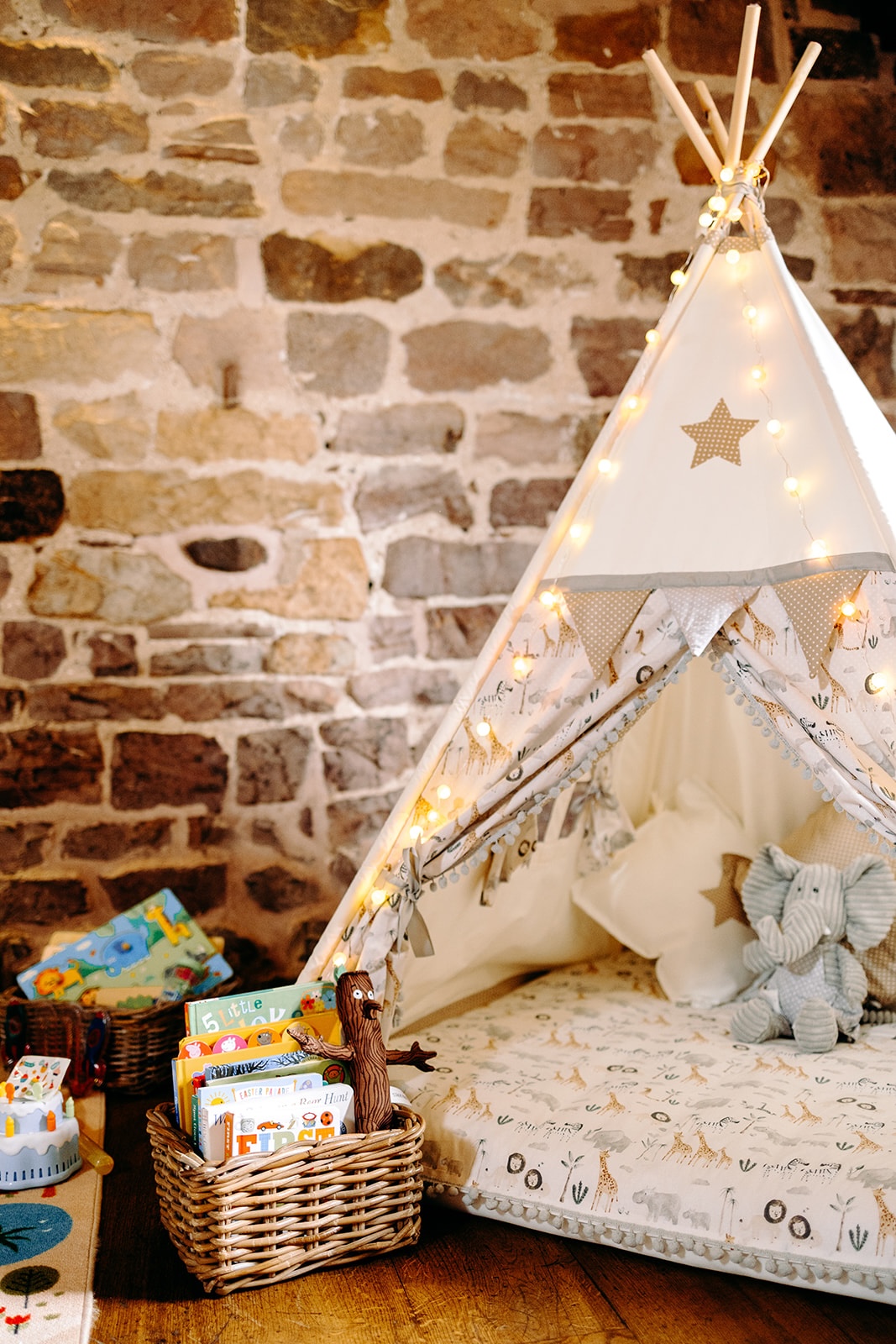 Children’s play area with cushions and toys inside Ashes Barns for a family-friendly wedding.