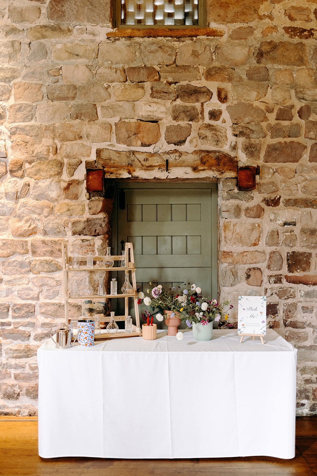Pick your own flowers wedding table styled against rustic stone walls at Ashes Barns.