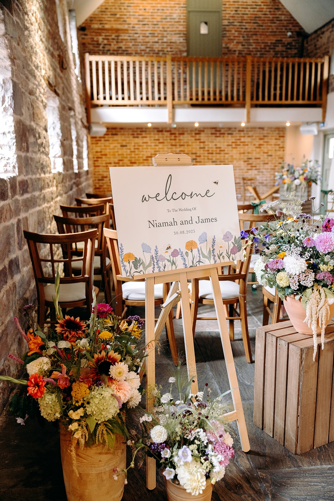 Welcome sign and floral styling inside Ashes Barns for a small, personal Peak District wedding.