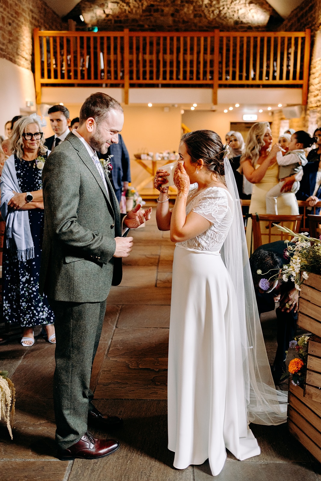 Emotional moment as the bride and father of the bride walk down the aisle inside Ashes Barns during the ceremony.