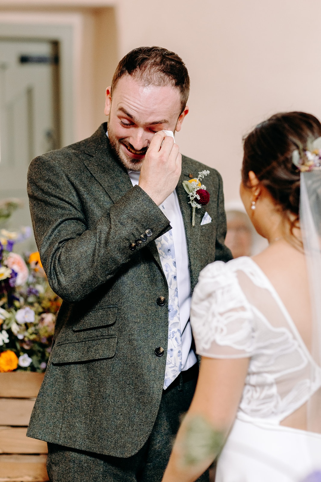 Emotional reaction during wedding vows inside the rustic stone barn at Ashes Barns.