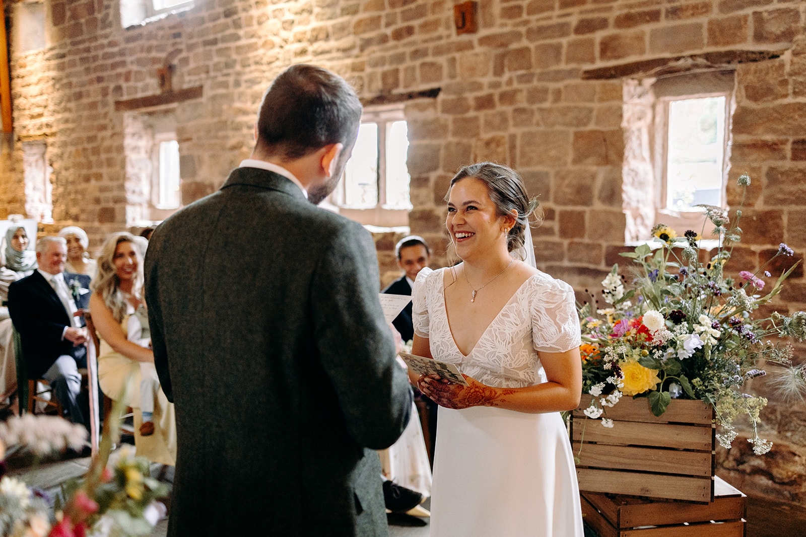 Couple facing each other during vows in the ceremony space at Ashes Barns.