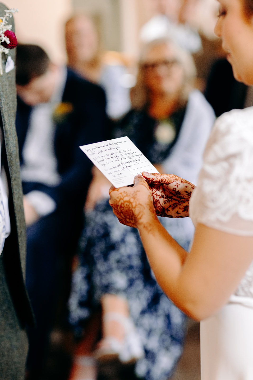 Bride reading handwritten vows during an intimate wedding ceremony at Ashes Barns.