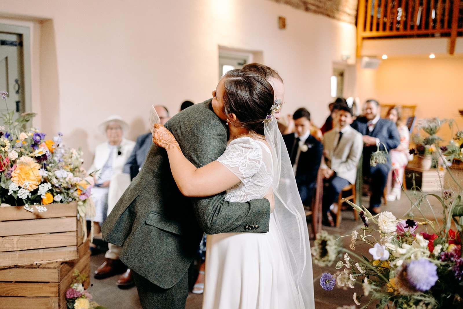 Couple embracing immediately after exchanging vows at Ashes Barns.
