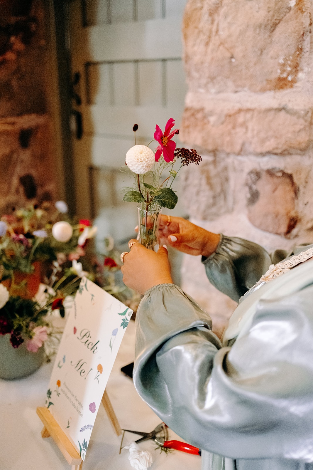 Close-up of floral details being admired during the drinks reception at Ashes Barns.