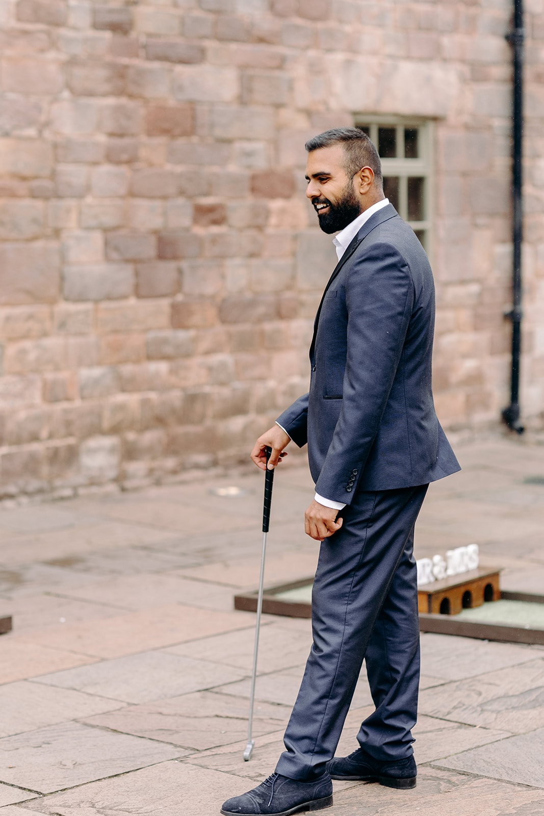 Guest playing golf outside Ashes Barns during a relaxed moment in the day.