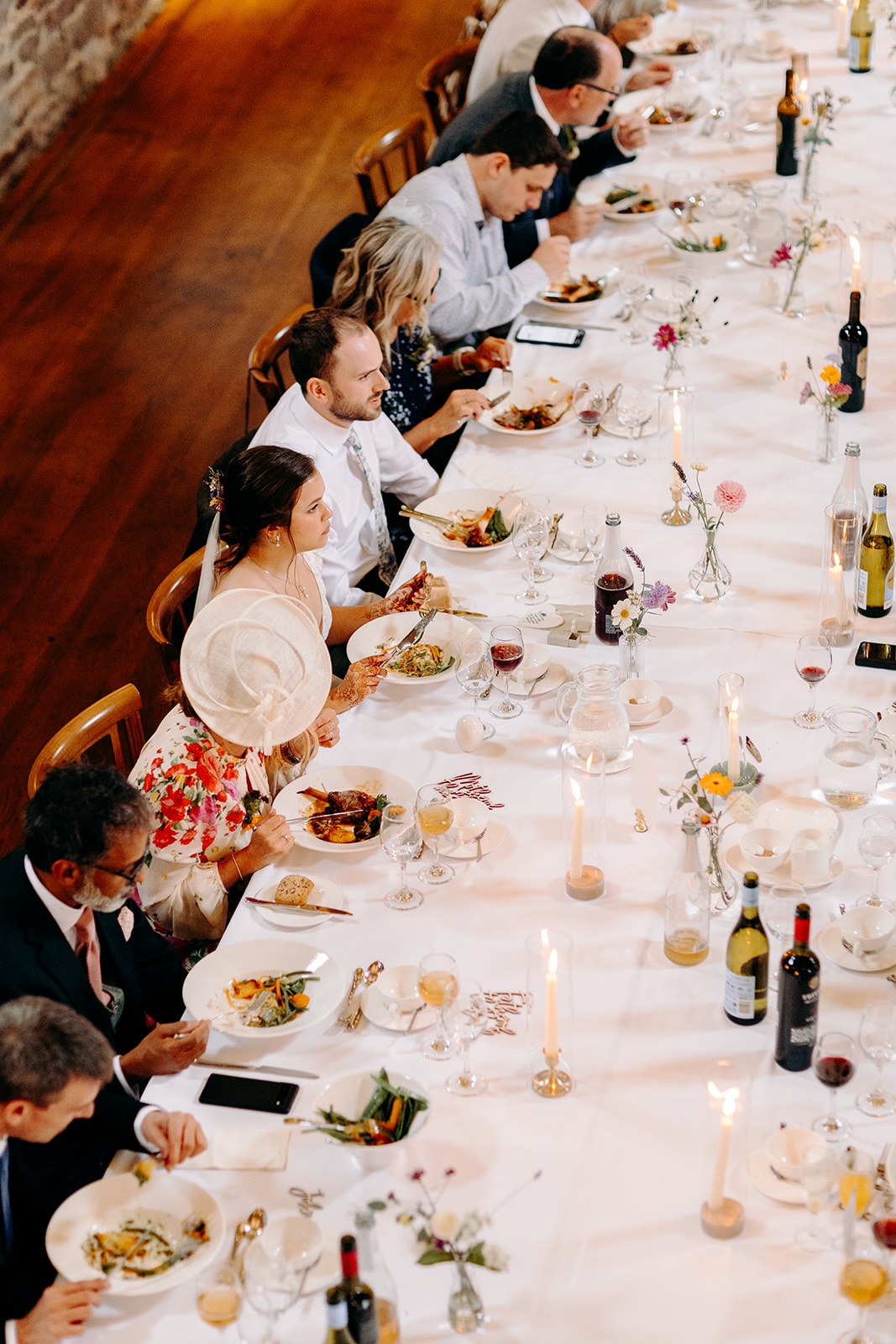 Overhead view of guests seated at long tables during the wedding breakfast at Ashes Barns.