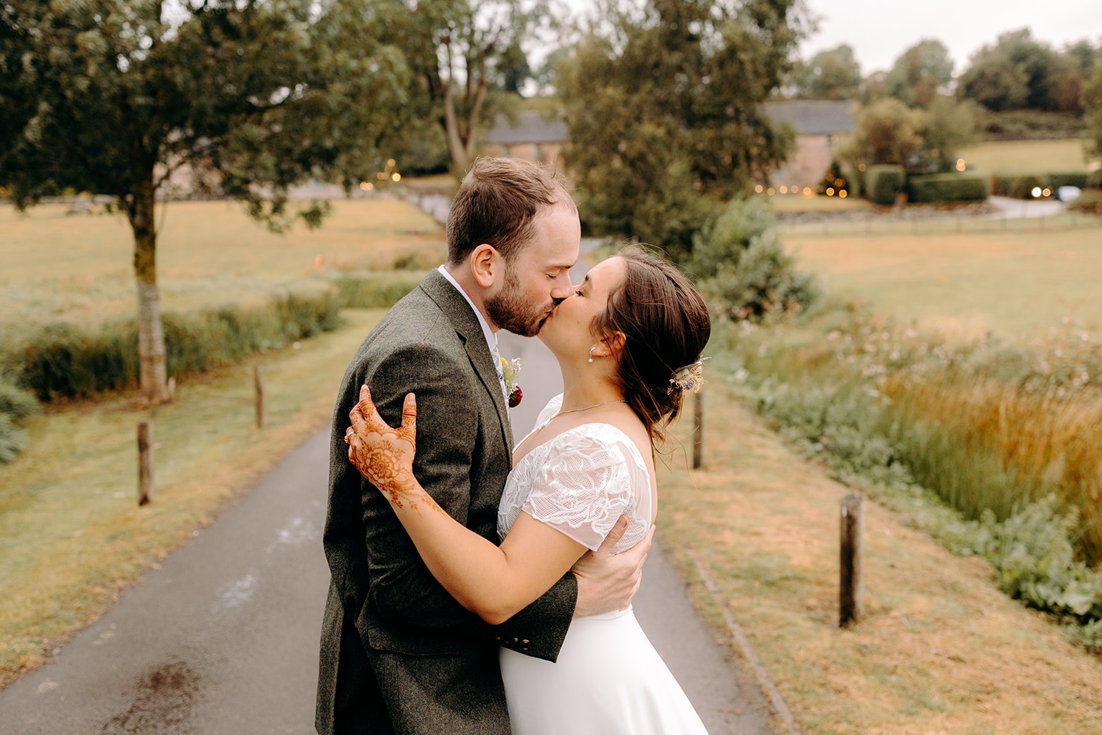 Close-up of the couple embracing during relaxed outdoor portraits near Ashes Barns.
