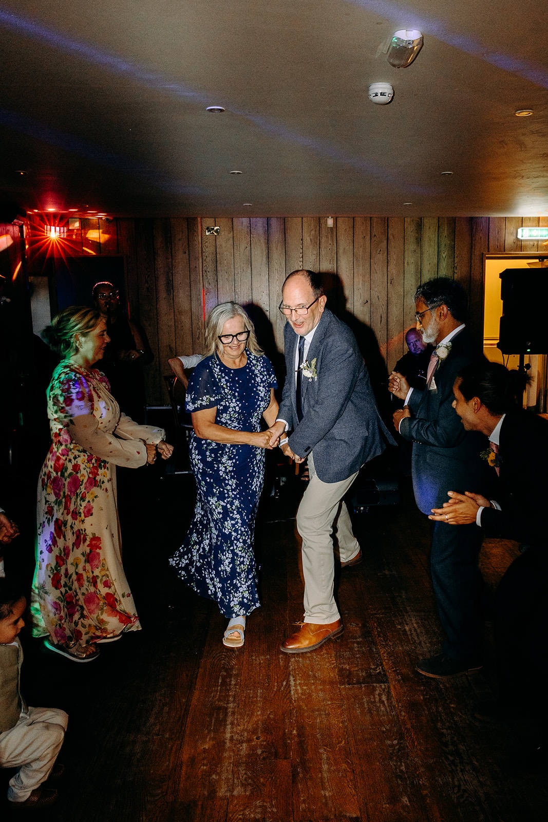 Energetic ceilidh dancing inside Ashes Barns, capturing the joyful atmosphere of the wedding evening.