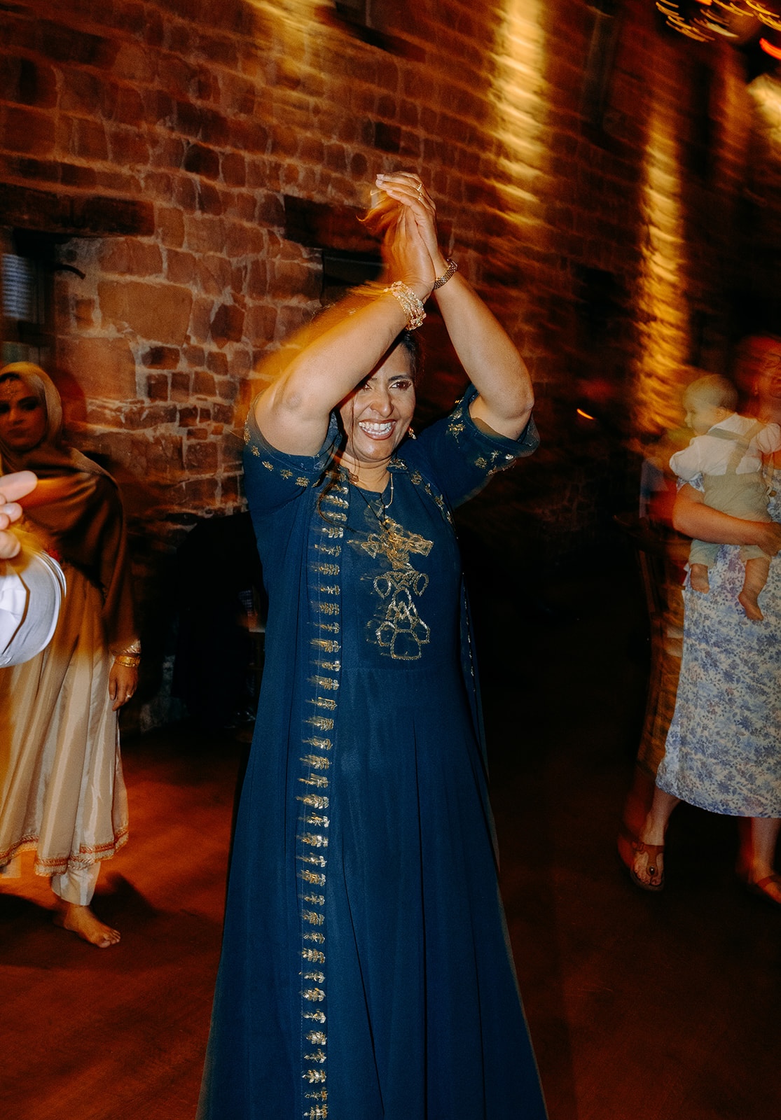 Guest clapping during ceilidh dancing at intimate wedding celebration at Ashes Barns.
