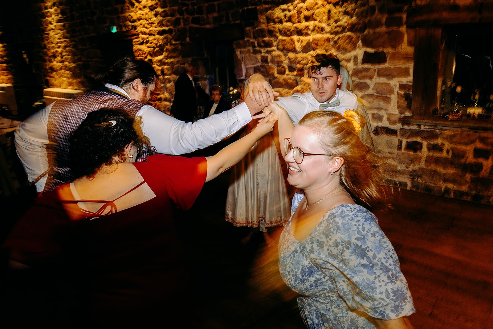 Guests all dancing together at an intimate wedding at The Ashes Barns.