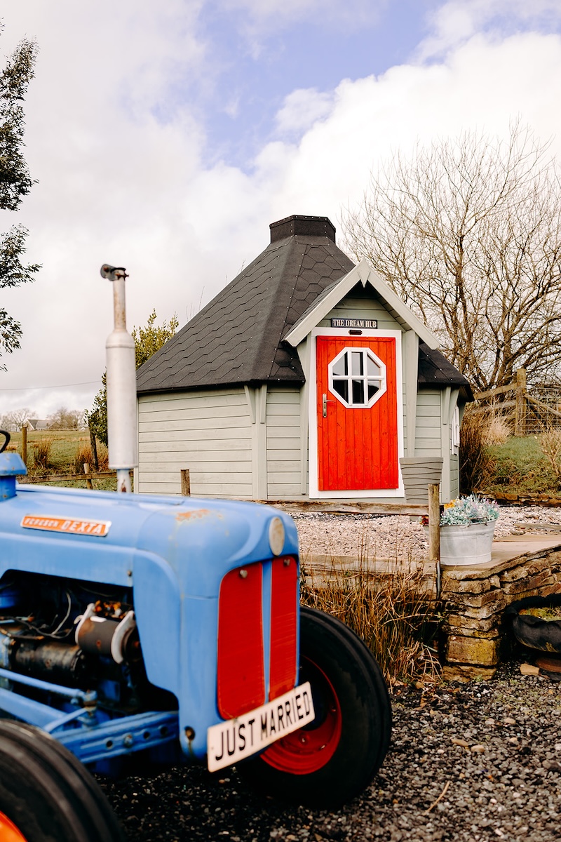 Exterior of the red barn at The Wellbeing Farm on a crisp winter morning, photographed for a February wedding with natural documentary wedding photography.