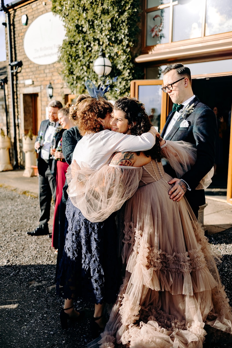 Guest interacting with one of the llamas during the wedding celebration, captured with documentary wedding photography.