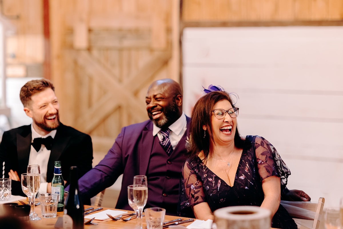 Wedding guests chatting and laughing together during the wedding breakfast at The Wellbeing Farm.