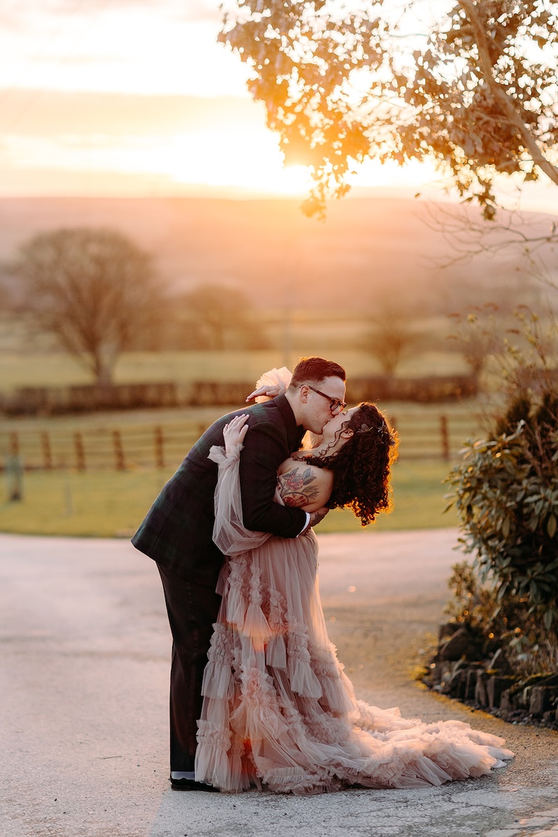 Bride and groom embracing in the sunset light during romantic winter wedding photography portraits.