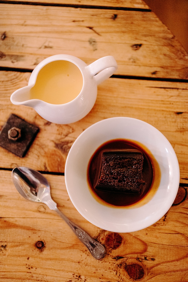 Dessert plate with chocolate cake and tea during the wedding breakfast, photographed by the wedding photographer.