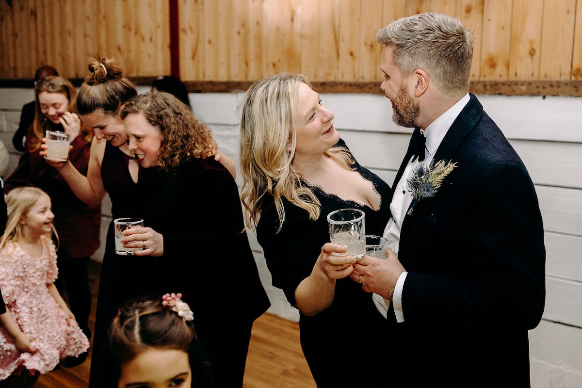 Wedding guests chatting together on the dancefloor during the evening party.