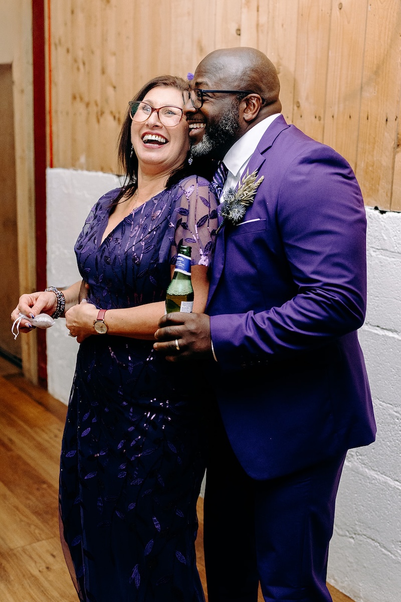 Guest couple dancing together during the lively reception celebration photographed by a wedding photographer.