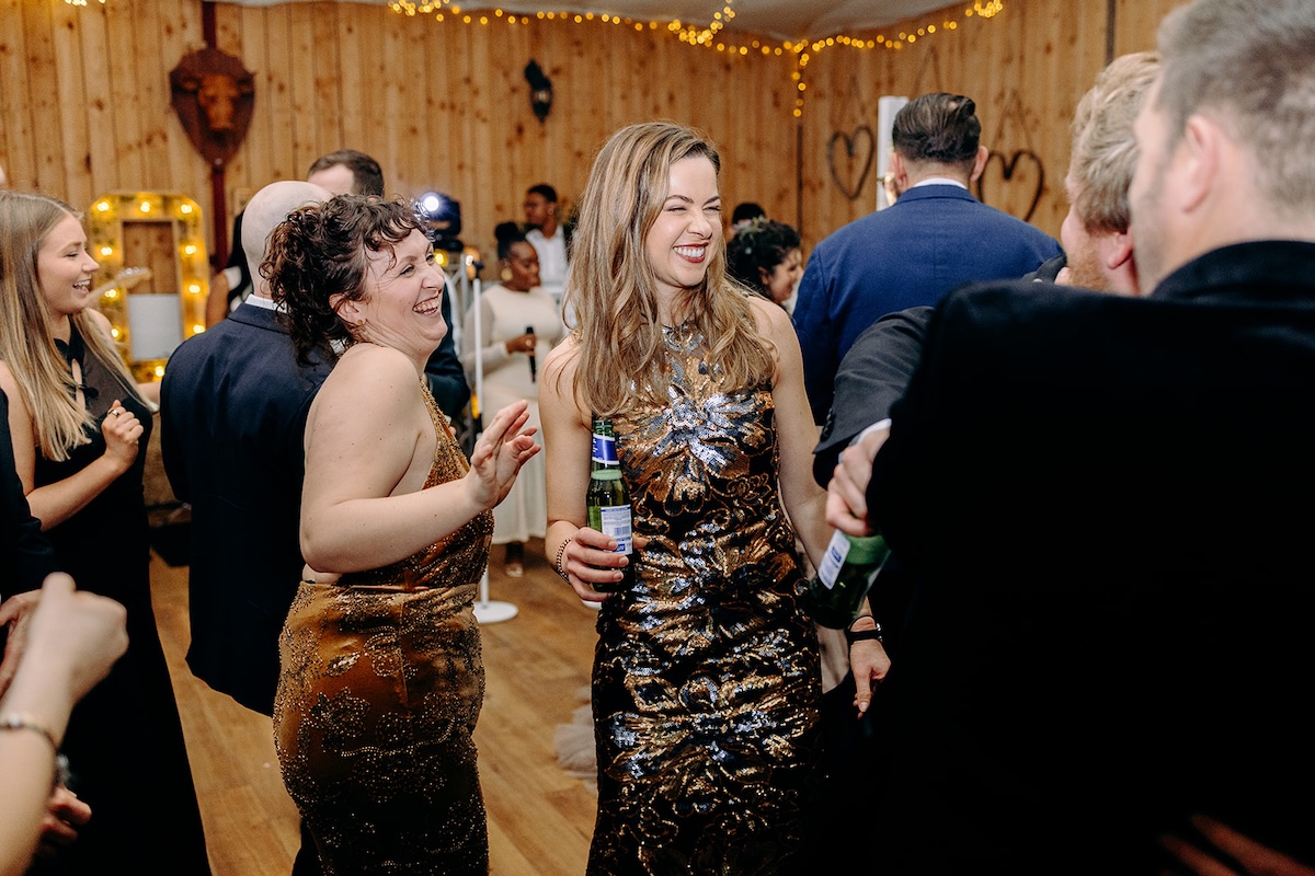 Guests dancing and chatting during the evening party captured with relaxed documentary wedding photography.