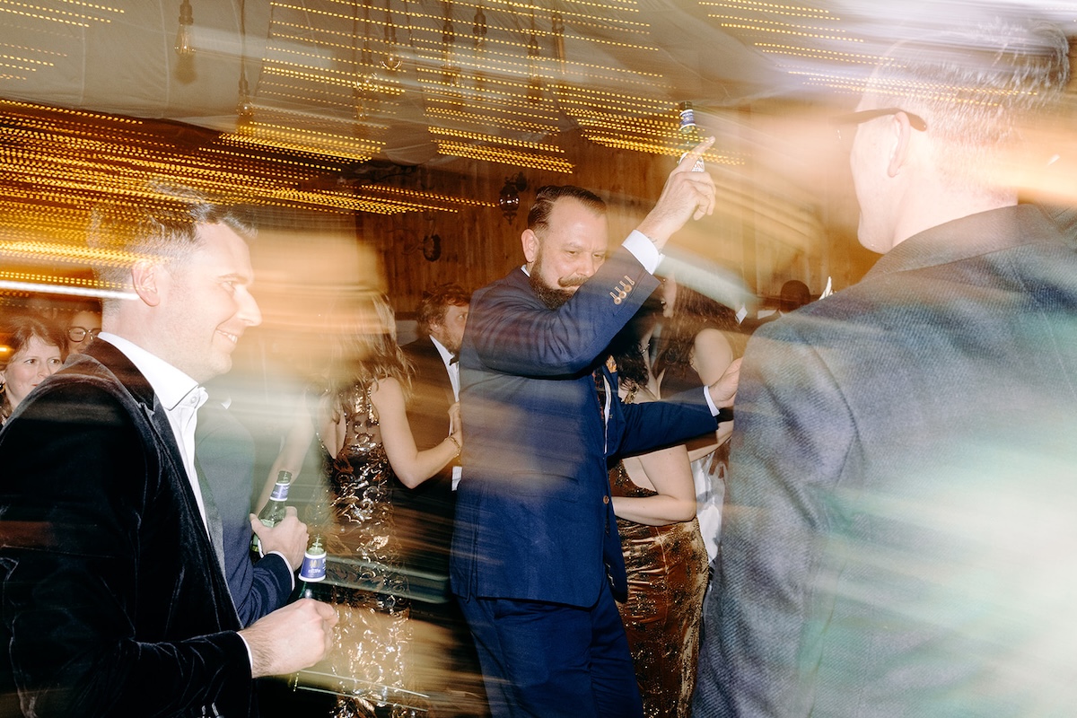 Wedding guest dancing energetically on the dancefloor during the band set photographed by a wedding photographer.