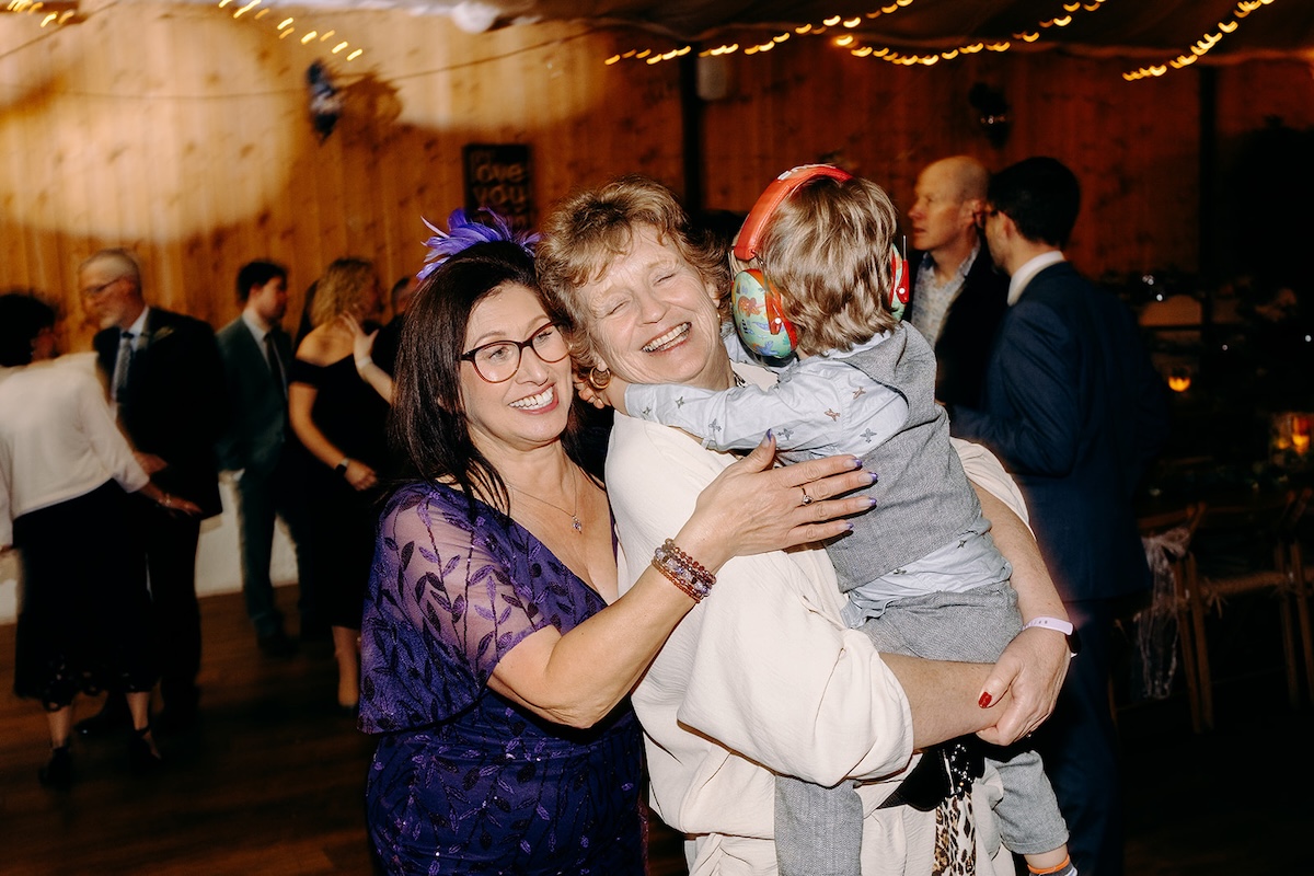 Guest hugging a child during the dancing at the evening reception.