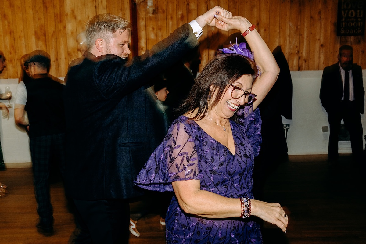 Guest spinning another guest on the dancefloor during the lively evening party.