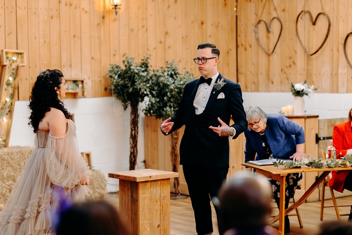 Bride and groom exchanging vows during their winter wedding ceremony at The Wellbeing Farm, photographed with natural documentary wedding photography.